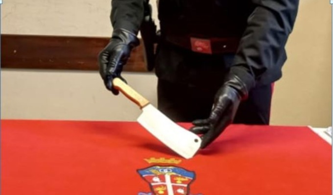 Litiga con i vicini prende una mannaia e tenta di sfondargli la porta di casa minacciandoli di morte